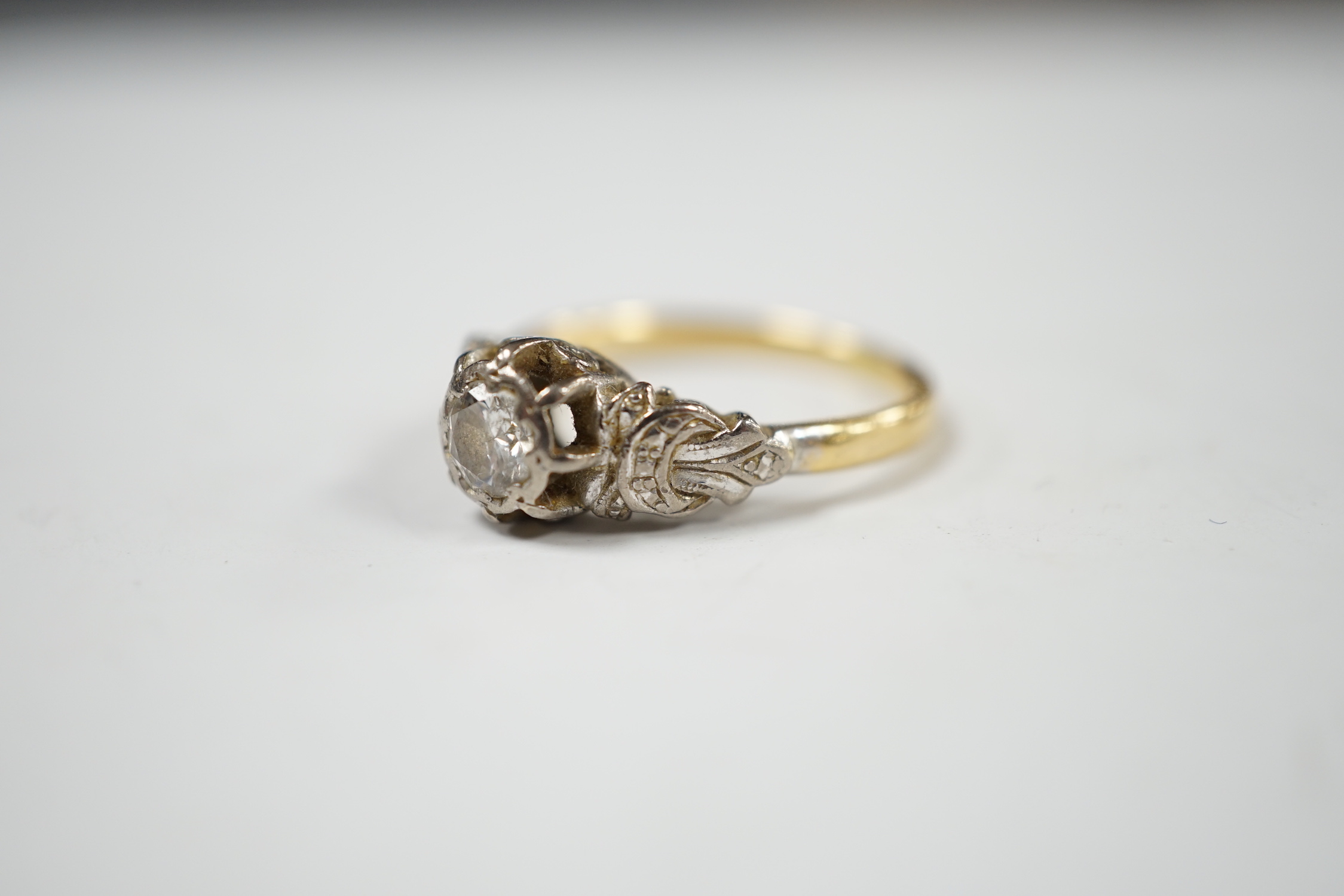 A yellow metal and illusion set solitaire diamond ring, size O, gross weight 3.8 grams.